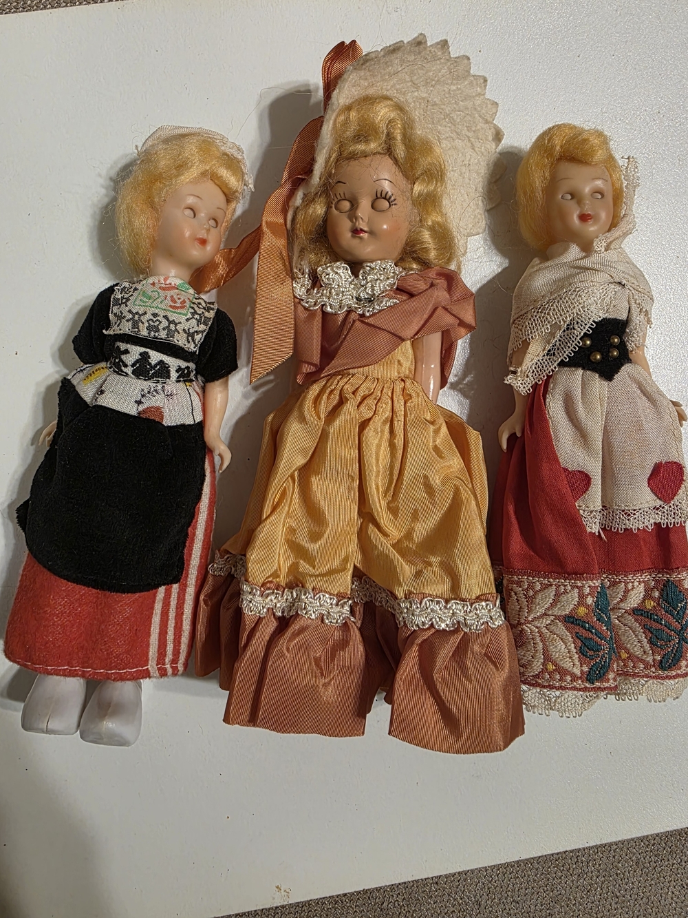 Vintage Trio of Blonde Doll Figurines in Red, Gold and Black Dresses